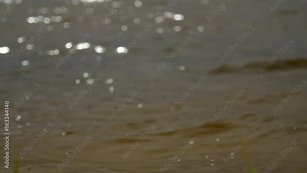 Lake water wavy surface, water greenish tint opaque