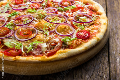 Delicious pizza with with onions, bacon and cherry
