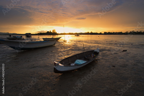 Small boat during a beautiful sunset somewhere in Sabah, North Borneo, Asia.