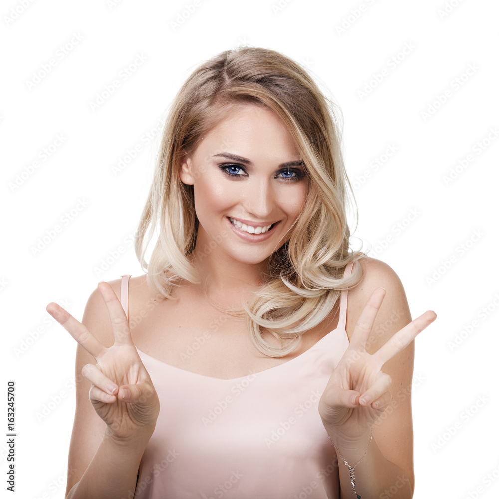 Portrait of a smiling girl isolated on white background. Model shows the symbol of victory Portrait of a smiling girl isolated on white background. Model shows the symbol of victory