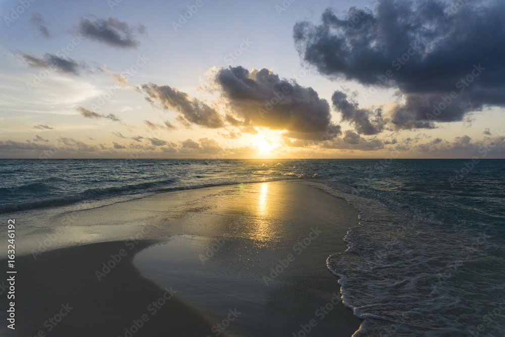 Dramatic sunset over tropical beach and sea