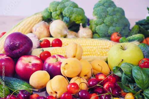 Vegetable abstract composition. Fresh vegetables  broccoli  carrot  corn  cucumber  garlic  onion  potatoes  salad  tomato  basil. Fresh Organic Vegetables. Summer Fruits  cherry  peaches  apricots.