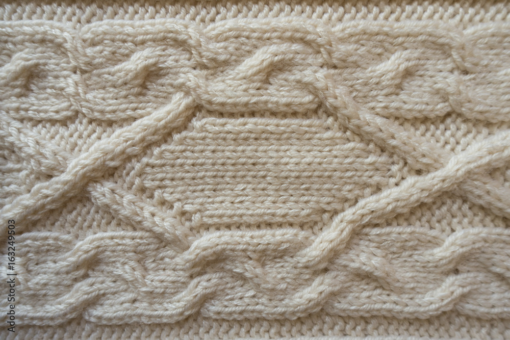 Cream handmade knitwork with horizontal plait pattern from above Cream handmade knitwork with horizontal plait pattern from above