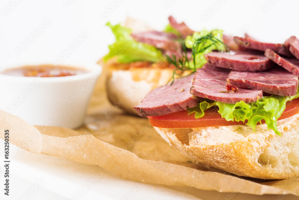 Bruschetta with beef on a plate on a white background.