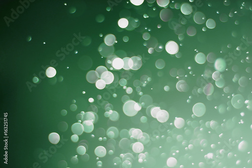 Beautiful and blurry bokeh on a green background.