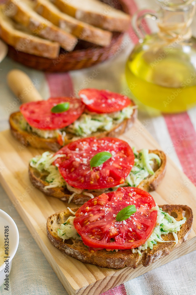Bruschetta topped with cucumber salad and tomato Bruschetta topped with cucumber salad and tomato