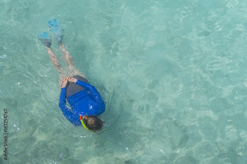 Woman snorkling in clear blue tropical sea