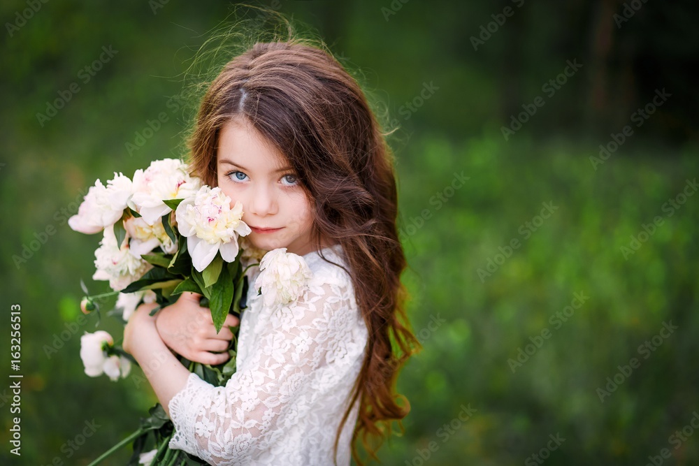 little girl six years old with brown hair and blue eyes with a bouquet of peony flowers wearung white dress, smiling little girl six years old with brown hair and blue eyes with a bouquet of peony flowers wearung white dress, smiling