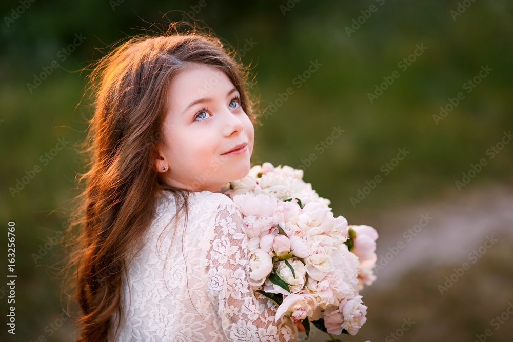 little girl six years old with brown hair and blue eyes with a bouquet of peony flowers wearung white dress, smiling little girl six years old with brown hair and blue eyes with a bouquet of peony flowers wearung white dress, smiling
