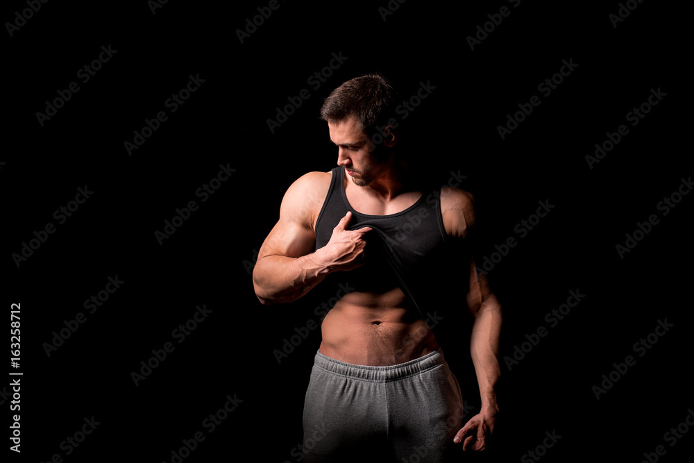 Young man with perfect body stripping Young man with perfect body stripping