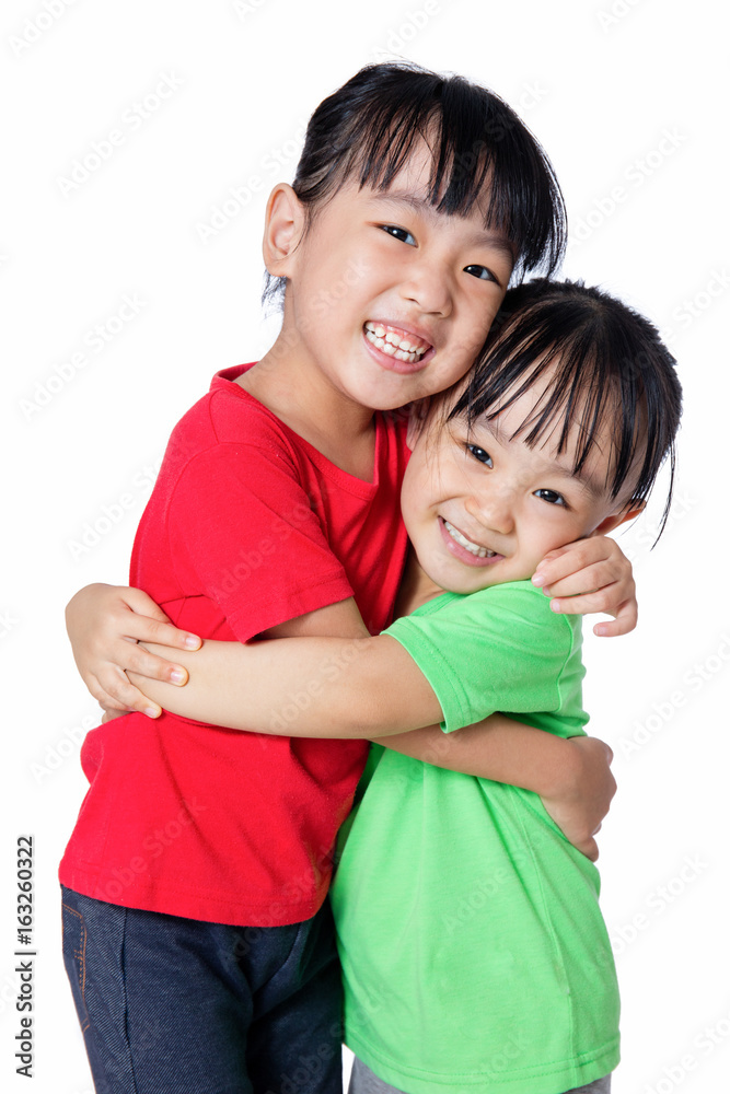 Asian Chinese little girls hugging each other Asian Chinese little girls hugging each other