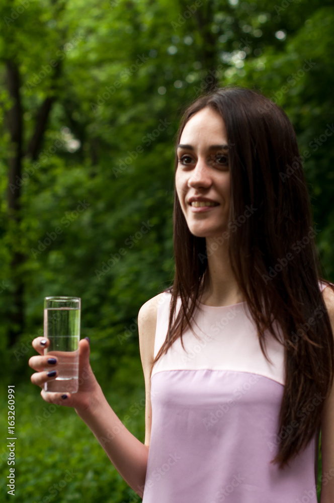 Portrait of young woman drinking water, outdoor, with copyspace Portrait of young woman drinking water, outdoor, with copyspace