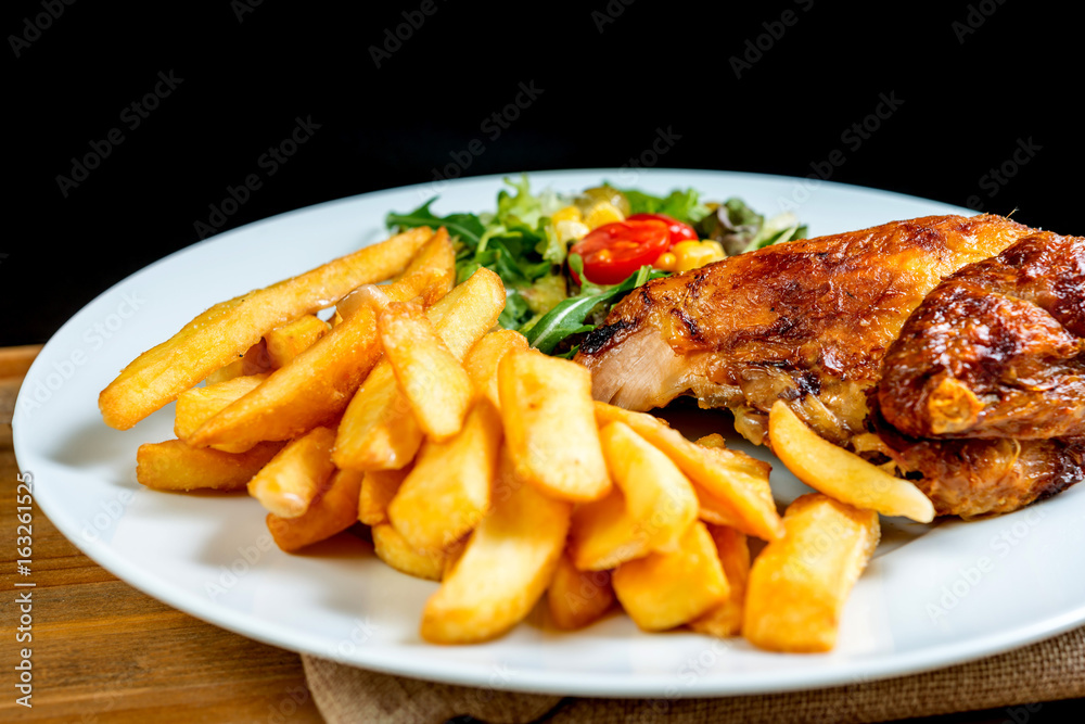 Fresh chicken with tomatoes and french fries Fresh chicken with tomatoes and french fries