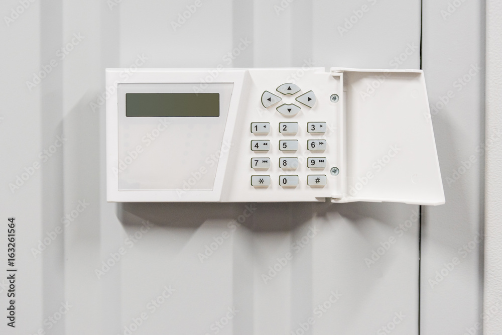 home security alarm on white wall, security system concept home security alarm on white wall, security system concept