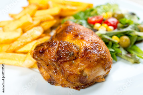 Fresh chicken with tomatoes and french fries