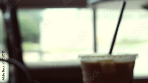 Filler shot of coffee shoppe - mocha caramel drink is picked up and placed on table photo