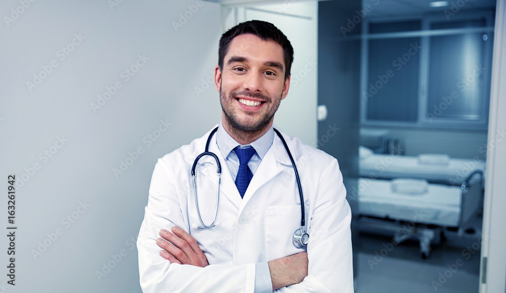 smiling doctor with stethoscope at hospital smiling doctor with stethoscope at hospital