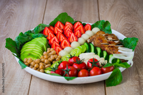 Warm grilled chicken salad with vegetables and fruits
