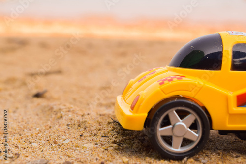 Yellow car on the sand.