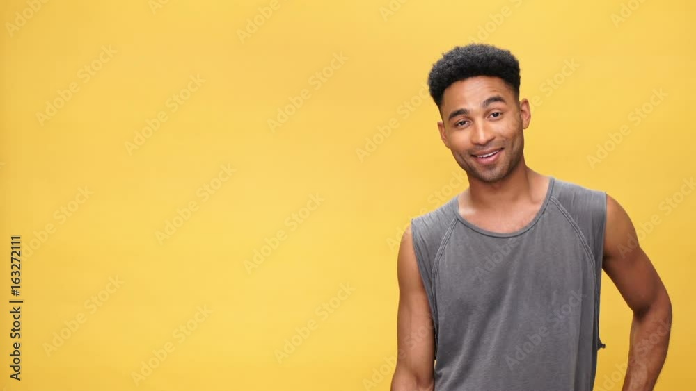 Young happy african man standing near copyspace over yellow background Young happy african man standing near copyspace over yellow background