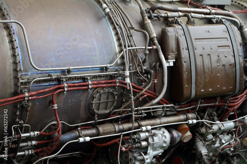 Pipelines and electric cables on the body of a aircraft engine.