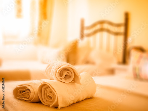 Clean towels on a bed in a holiday apartment / hotel