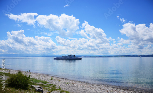 Tourist boat at Lake Constance with blue sky and small clouds at far horizon