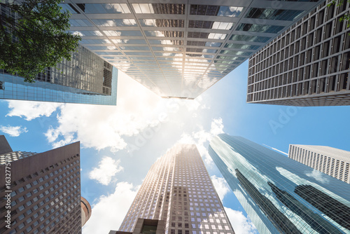 Upward view of skyscrapers against a cloud blue sky in the business district area of downtown Houston, Texas, US.