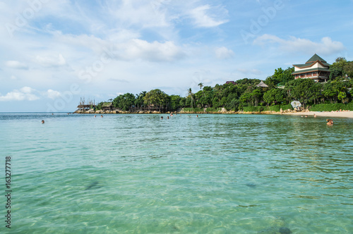 Beautiful Bay and Beach with Palms, Resort and People Swimming on Koh Pha Ngan, Thailand