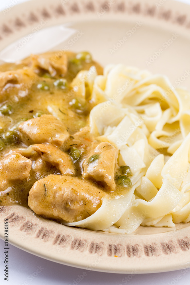 White chicken meat with sauce on the plate in closeup macro. White chicken meat with sauce on the plate in closeup macro.