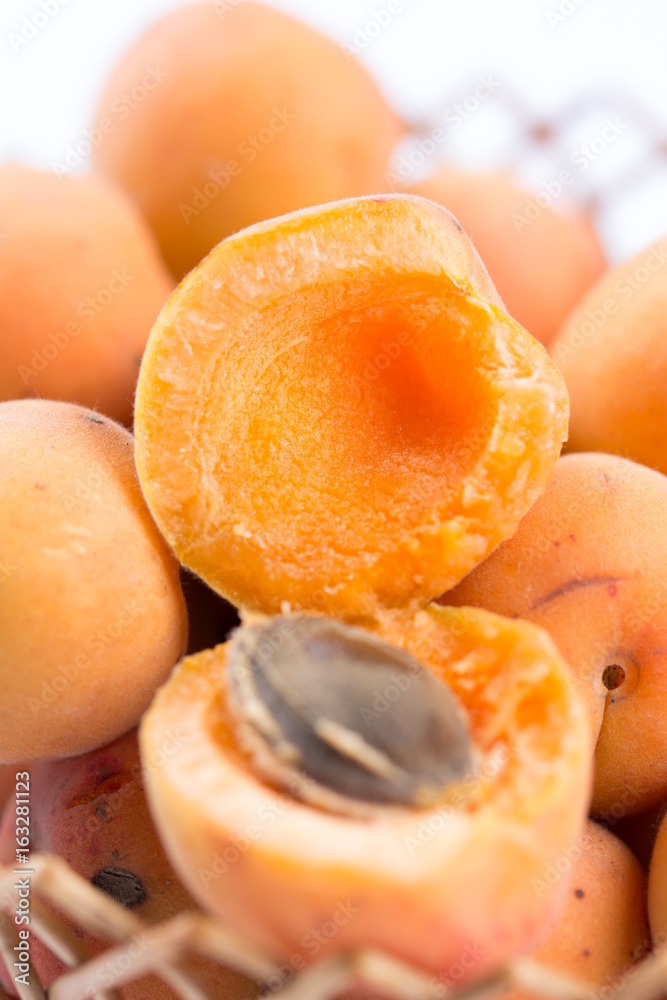 Closeup macro opened fresh apricots in the bowl. Closeup macro opened fresh apricots in the bowl.