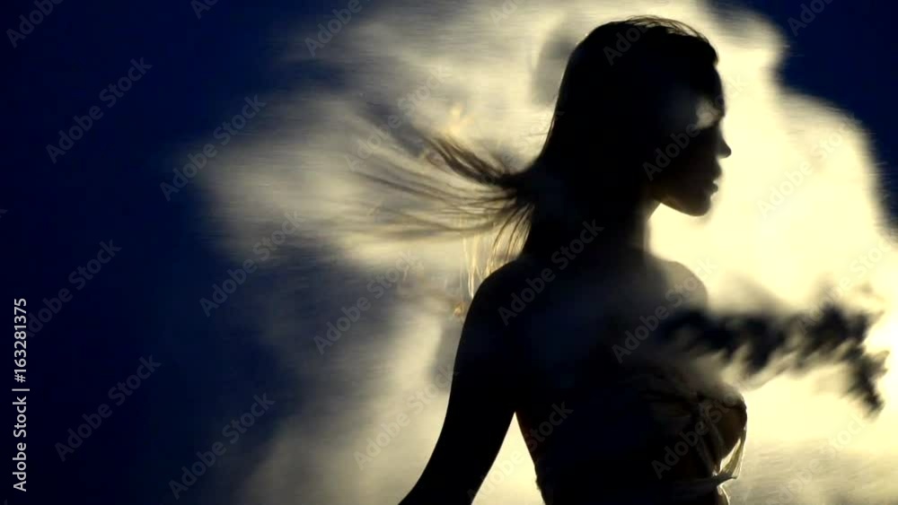 Mummy woman with flying hair causes a sandstorm in the night desert
