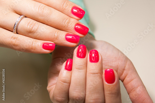 Manicure - Beauty treatment photo of nice manicured woman fingernails with red nail polish
