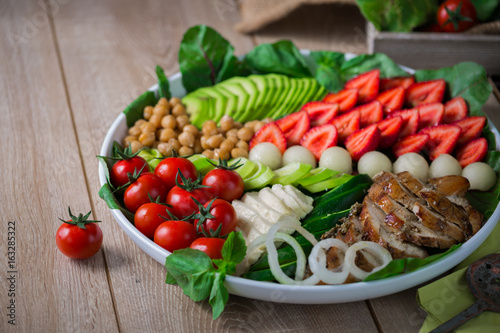 Warm grilled chicken salad with vegetables and fruits