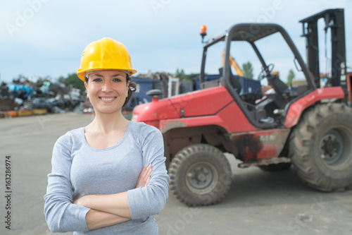Portrait of woman in salvage yard
