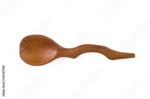 Old rustic, ornate, curved, wooden spoon