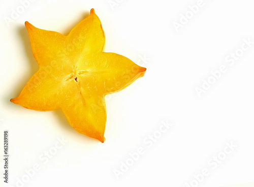 Closed up orange yellow sliced ripe Star Fruit on white background, with free space for text and design 