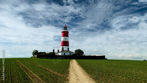 Happisburgh lighthouse blue cloudy sky