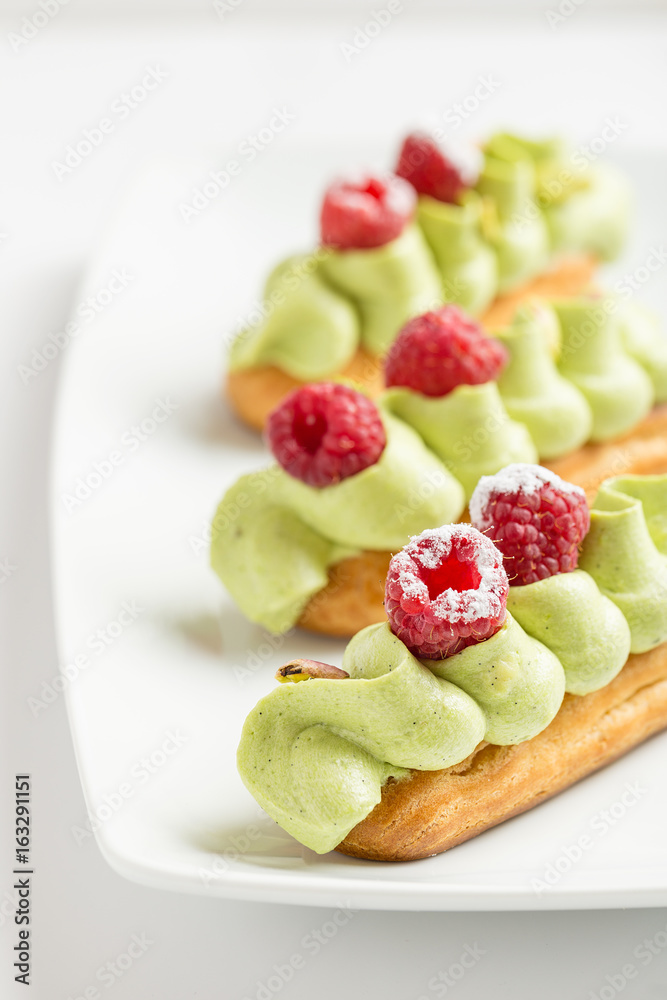 Eclaire with pistachio cream and strawberries Eclaire with pistachio cream and strawberries
