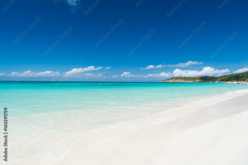 Beach with white sand, turquoise sea and blue sky