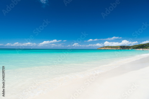 Beach with white sand, turquoise sea and blue sky