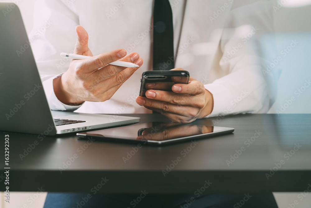 Fototapeta premium close up of businessman working with smart phone on wooden desk in modern office with virtual icon diagram with glass reflected view