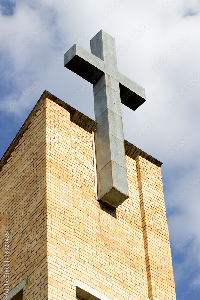 Cross Methodist Church on a background of blue sky with clouds on a sunny day