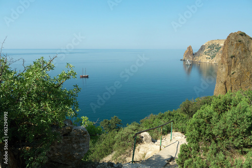seascape with Yachts on the background of rocks photo