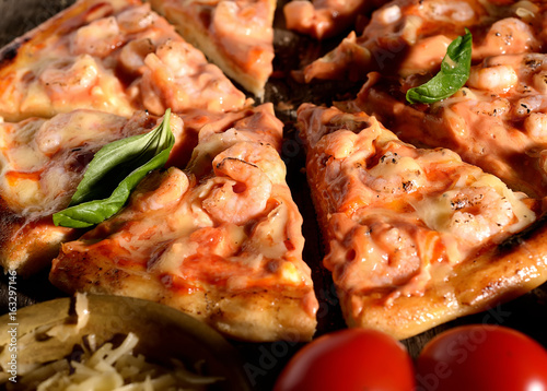 Pizza with shrimps on a wooden background