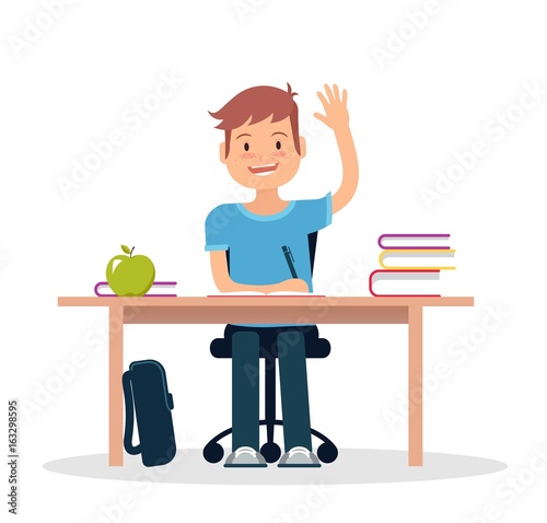 Schoolboy in classroom sitting at his desk and learning. Elementary school pupil raising hand. Vector illustration.