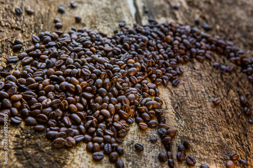 Coffee beans on wood texture background photo