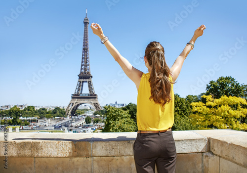 young woman in bright blouse rejoicing in Paris, France © Alliance
