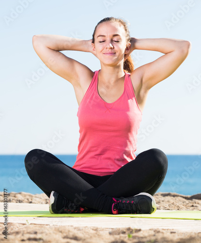 vigorous girl exercising on exercise mat outdoor
