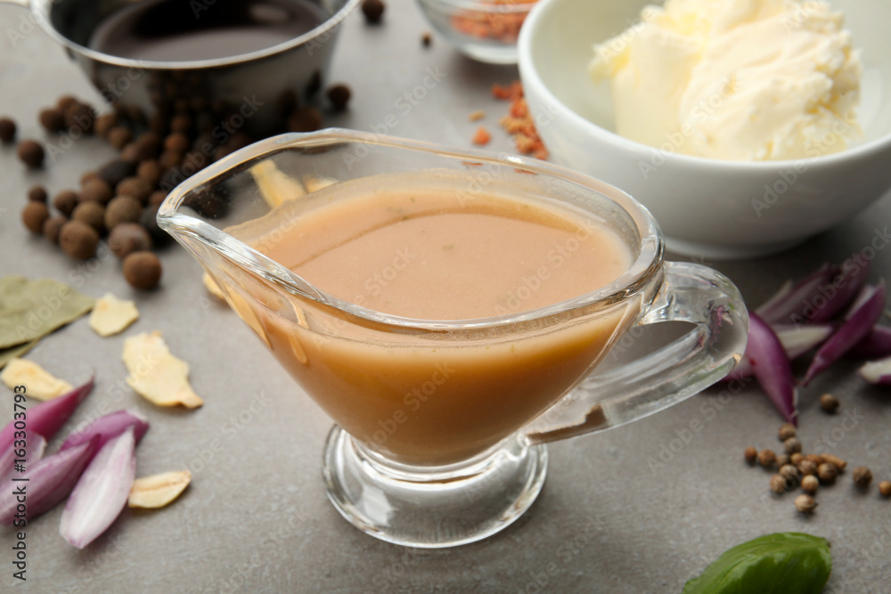 Sauce boat with turkey gravy and spices on table Sauce boat with turkey gravy and spices on table